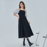 Elegant mid-length little black dress with puff sleeves